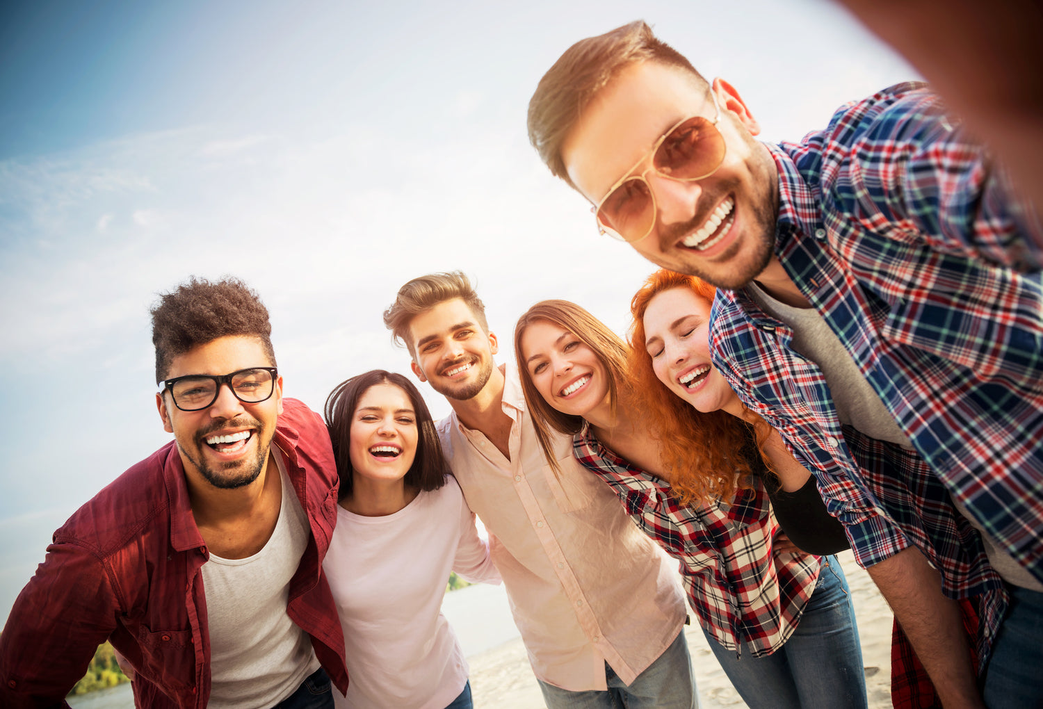 Group of young people having fun outdoors on the beach.